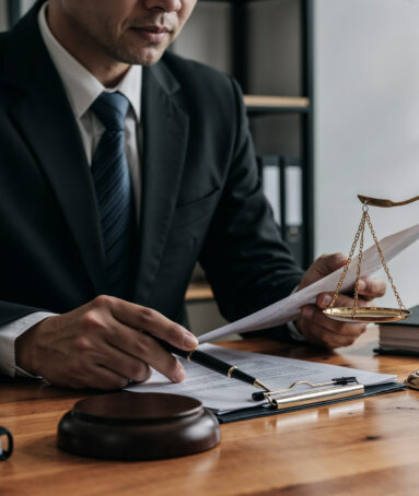 lawyer-working-document-with-scales-justice
